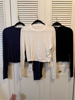 Women’s Long-Sleeve Crewneck Top — White, Black and Navy.